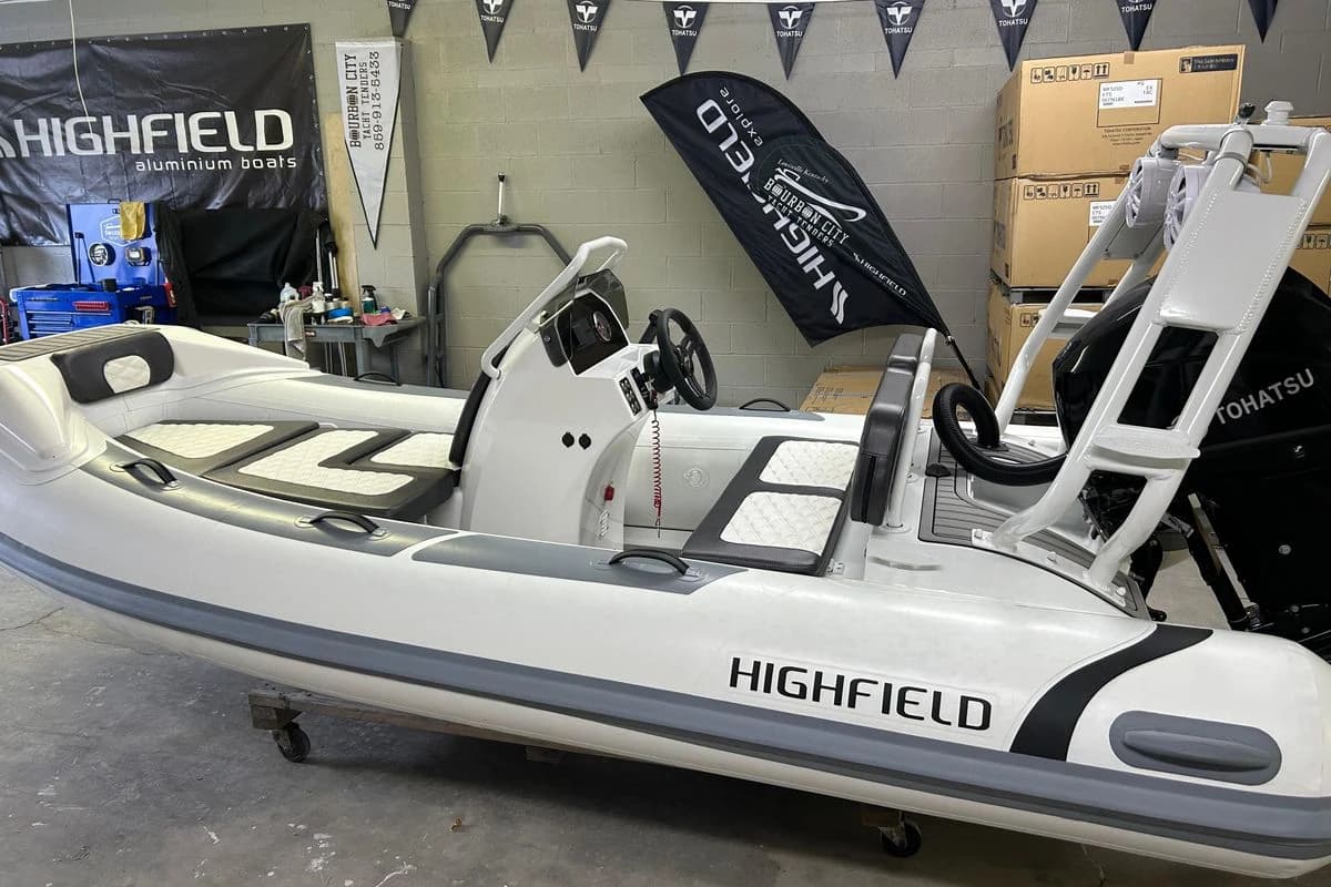2025 Highfield Sport 390 boat in showroom, featuring sleek design and Tohatsu engine.